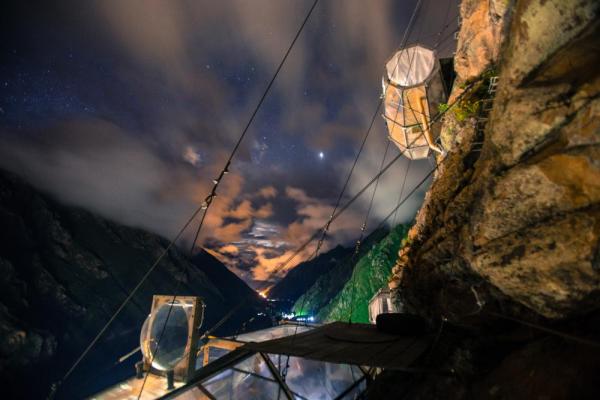 Spend the night inside a cubicle suspended on a mountain cliff